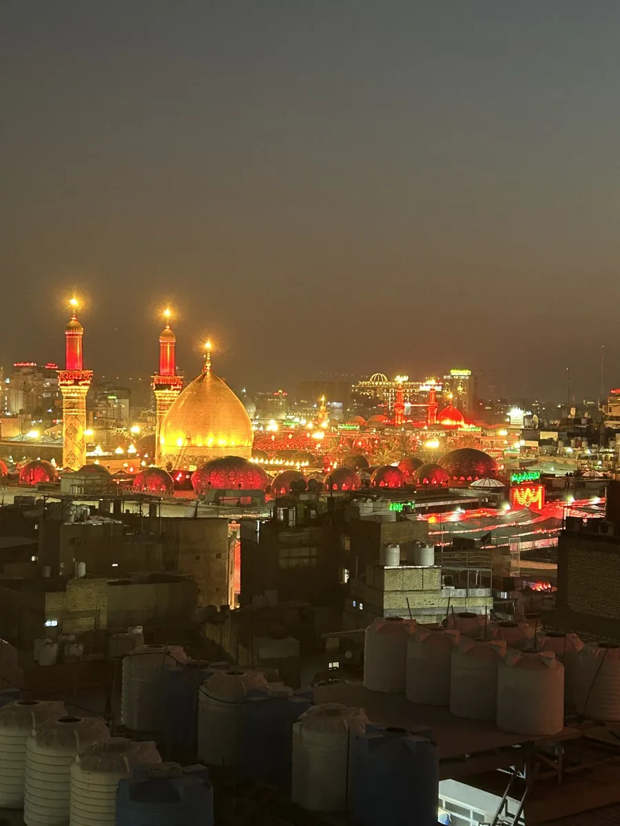 Illuminated shrine domes and minarets at night